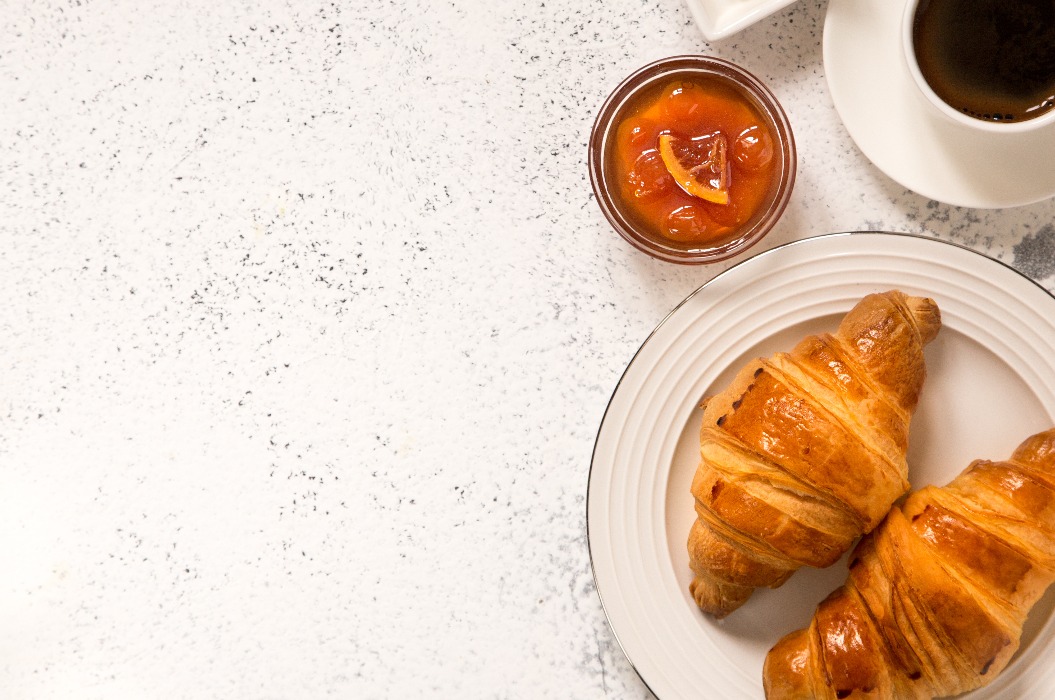 Frühstück mit Croissants. Frische, knusprige Croissants und Kaffee am